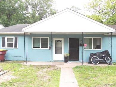 Single story home featuring concrete block siding,
