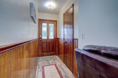 Foyer entrance with light hardwood / wood-style fl