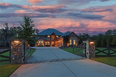 View of front facade with a gate, concrete driveway, and a fenced front yard