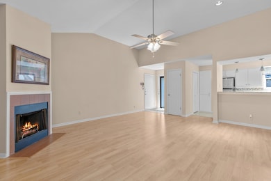 Unfurnished living room with vaulted ceiling, lig