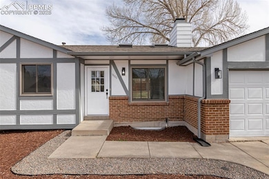 Entrance to property featuring an attached garage,