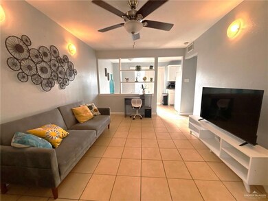 Living area with baseboards, a ceiling fan, and light tile patterned flooring