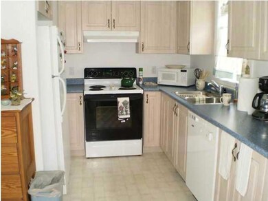 Kitchen. The galley-style kitchen is...