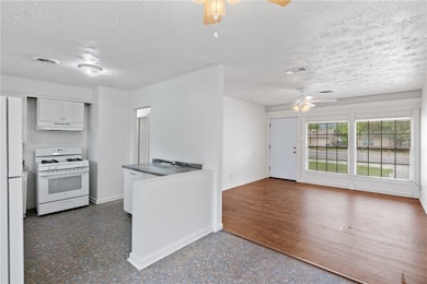 Kitchen with ceiling fan, white appliances, under