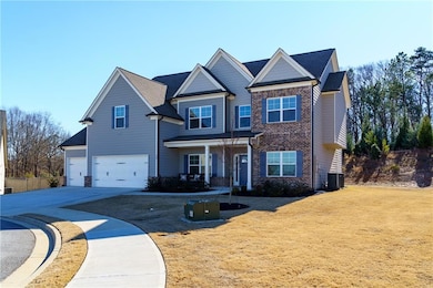 Craftsman-style home with central AC unit, a garag