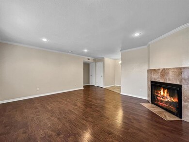 Unfurnished living room featuring dark hardwood / wood-style floors, and a tiled fireplace