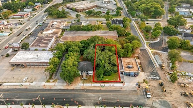 Aerial view of property and surrounding area with property parcel outlined