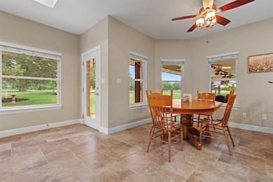 Dining area with stone tile floors, baseboards, a