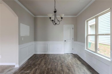 Unfurnished dining area with dark hardwood / wood-