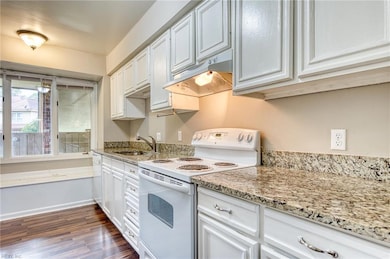 white cabinets, granite countertops, all appliances convey
