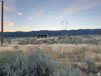 View of mountain backdrop featuring rural landscape