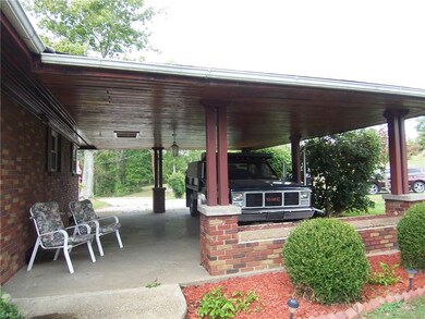 Carport view showing tongue and groove wood ceilin