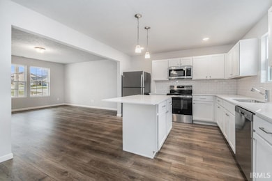 The kitchen includes a center island with extended