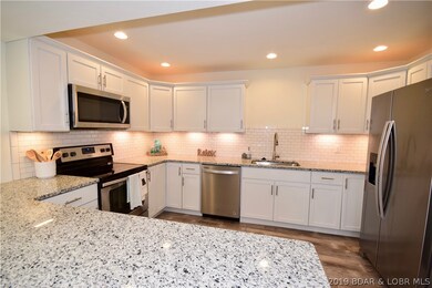 Beautifully redone kitchen with granite counter tops and custom cabinets. All stainless steel appliances come with the home!