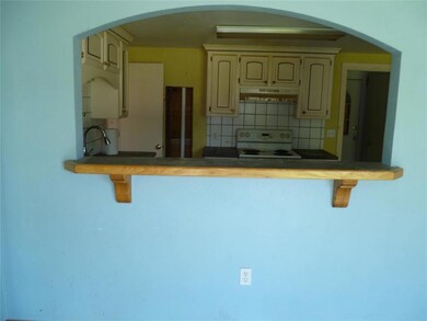 Kitchen featuring sink, cream cabinetry, backsplas