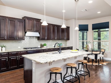 Kitchen with decorative backsplash, visible vents
