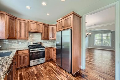 Kitchen with an inviting chandelier, a sink, appli