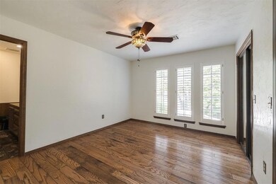 Spare room with ceiling fan and hardwood / wood-st