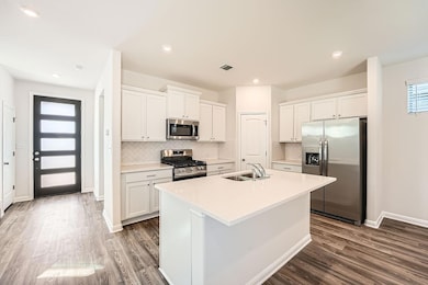 Kitchen with stainless steel appliances, dark woo