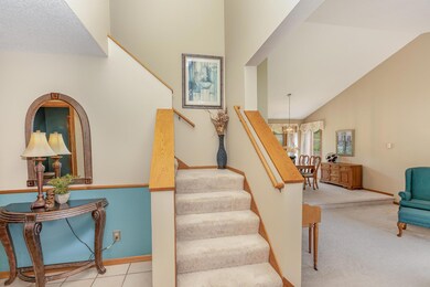 Grand entry with 17' ceiling with views of the open staircase and living room.