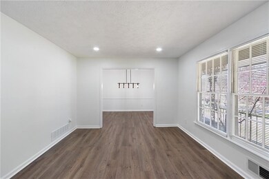 Unfurnished dining area with dark wood-type floori