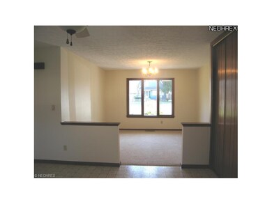 This room off the kitchen can serve as formal Dini