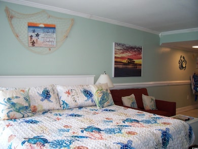 Bedroom with crown molding and baseboards