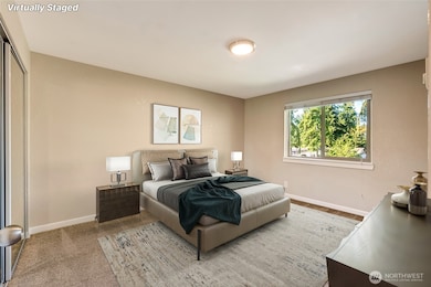 Primary bedroom with wide, mirrored closet for extra storage.
