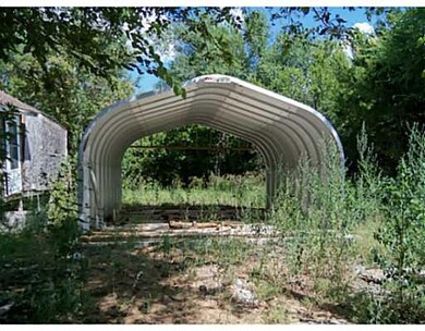 Land. A Structure that could be used as a car port