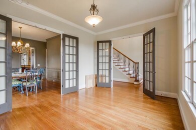 French doors open to the living room or main floor home office/library space. Additional set of french doors to the dining room allows for easy entertaining or a private dinner setting. 