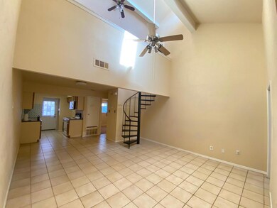 Unfurnished living room featuring light tile patte