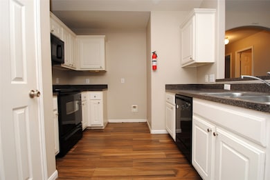 This kitchen features modern black appliances, whi