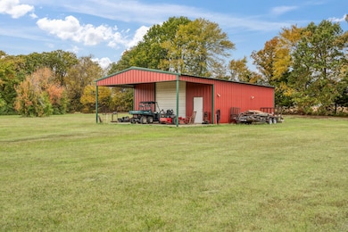 View of pole building with a lawn