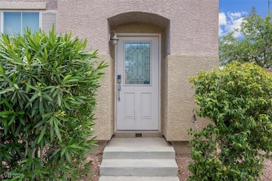 Doorway to property featuring stucco siding