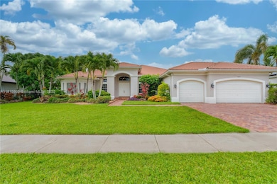 Front view of 3-car garage estate in guard-gated Riverstone