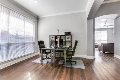 Dining area with dark hardwood / wood-style floors, ceiling fan, and ornamental molding