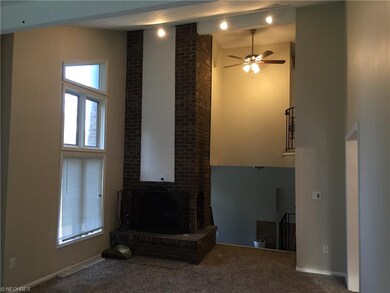 Two Story Living Room with two-sided fireplace and open archway