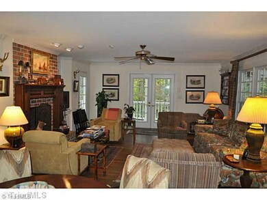Den/Family/Great Room. A large den with the second of the homes masonry fireplaces opens out to a grand wrap around porch and the home s charming gazebo.