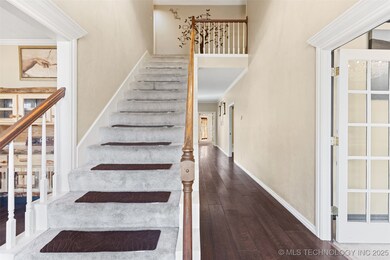 Stairs with wood-type flooring, baseboards, and cr