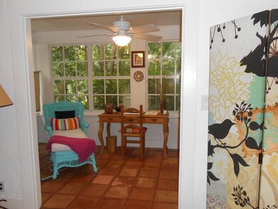 Sun room off the living area is the perfect home office or art studio with abundance of natural light.