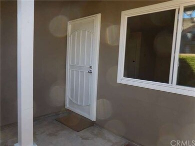 The front door, with security screen, is at side o