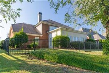 Rear view of the home showing  and fence!