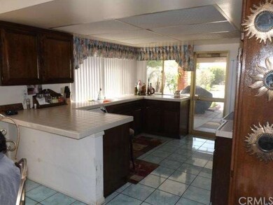 Kitchen with breakfast bar and door leading to pat