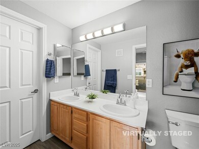 Full bathroom featuring double sink vanity and wal