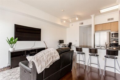 Living area featuring dark wood finished floors, a desk, and track lighting