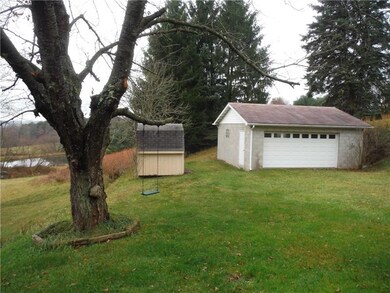Rear yard with shed and detached garage.