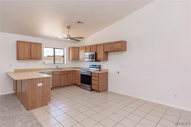 Kitchen featuring light tile patterned floors, vau