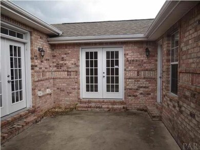 COURT YARD AREA SHOWING FRENCH DOORS LEADING TO HALL AREA BETWEEN MAIN HOUSE AND GUEST SUITE. PRIVATE ENTRY TO GUEST SUITE IS ON THE RIGHT SIDE OF THIS PHOTO