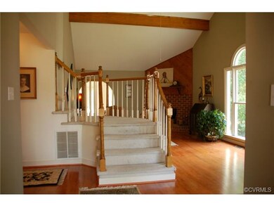Open and bright entryway with refinished hardwood 