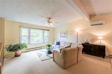 Bright and spacious living room with vaulted ceiling open to dining area.